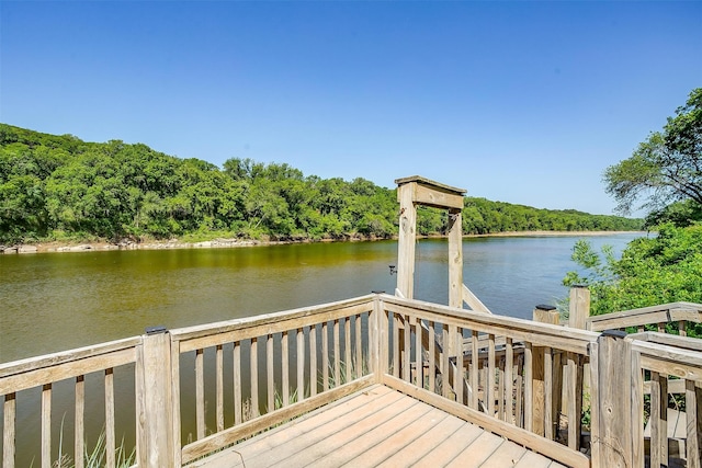 deck with a dock and a water view