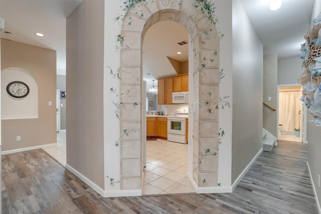 corridor featuring light tile flooring