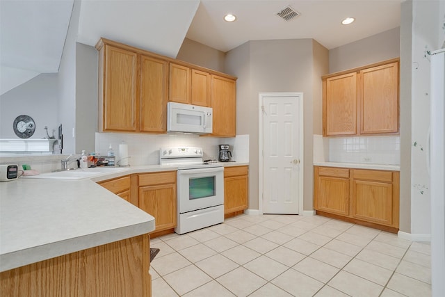 kitchen featuring white appliances, sink, backsplash, and light tile floors