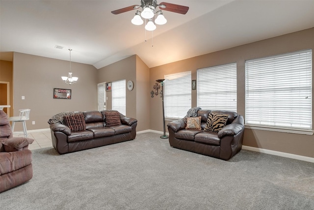 carpeted living room with plenty of natural light, ceiling fan with notable chandelier, and lofted ceiling