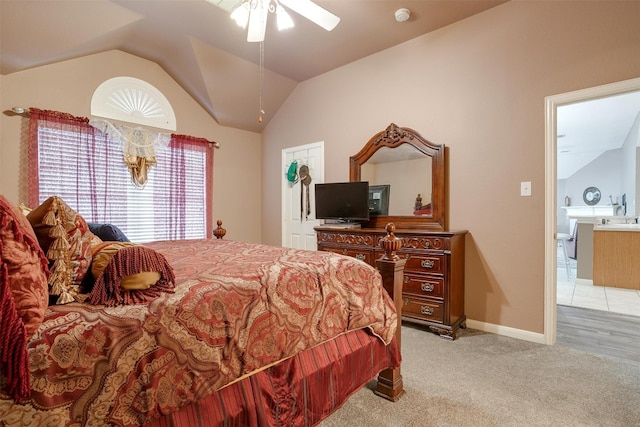 carpeted bedroom featuring ceiling fan and vaulted ceiling