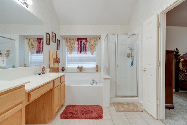 bathroom with tile floors, large vanity, and shower with separate bathtub