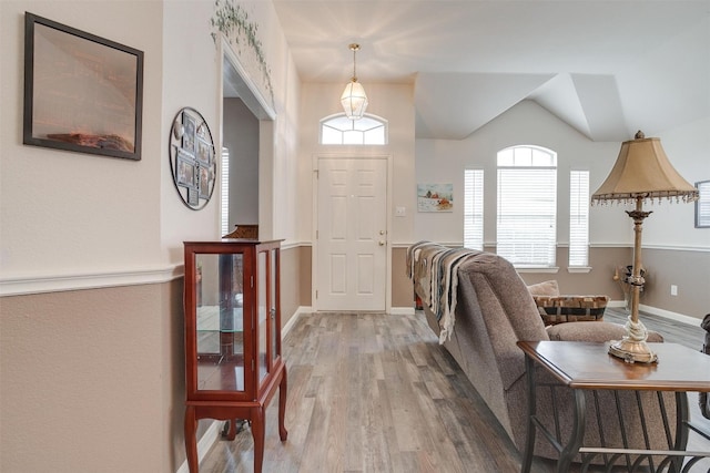 entryway with hardwood / wood-style flooring and lofted ceiling