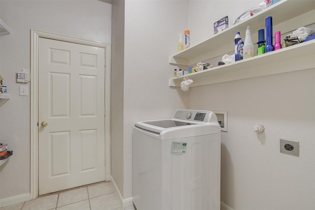 clothes washing area featuring light tile flooring and washer / clothes dryer