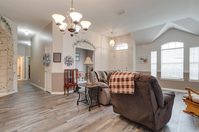 living room featuring wood-type flooring and a chandelier