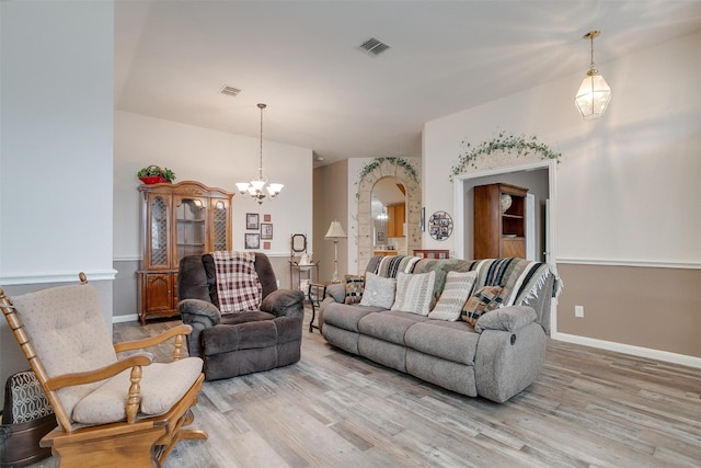 living room featuring hardwood / wood-style flooring and an inviting chandelier