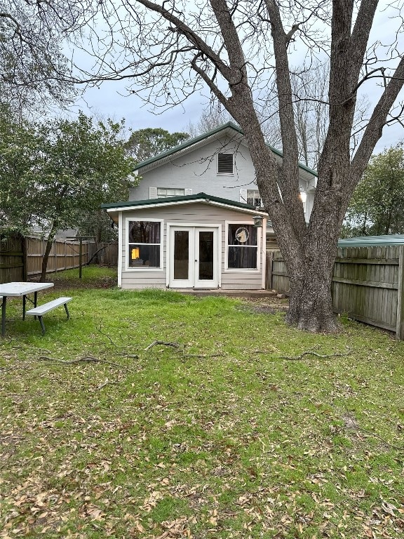 rear view of property with a yard and french doors