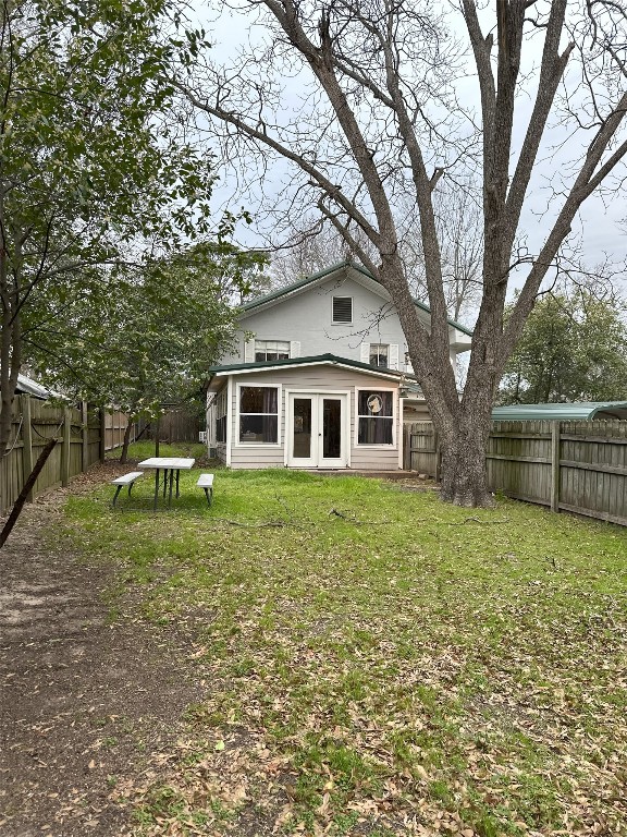 back of property featuring a lawn