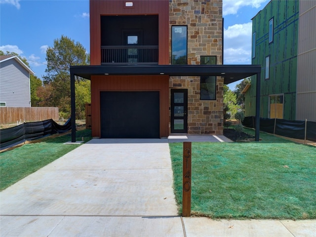 contemporary home with a front lawn, a balcony, and a garage