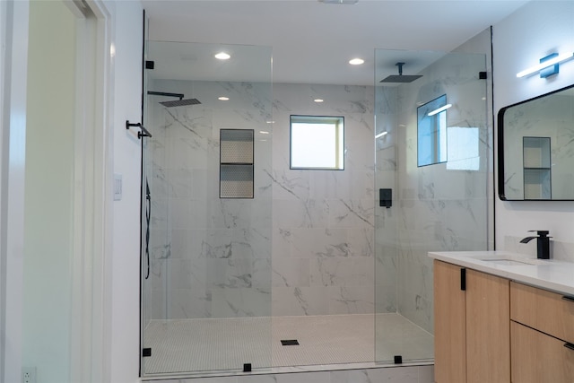 bathroom with vanity and a shower with shower door