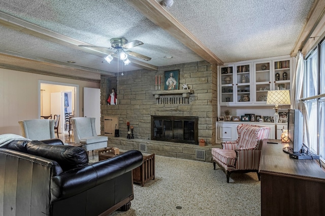 carpeted living room with beam ceiling, ceiling fan, a textured ceiling, and a fireplace