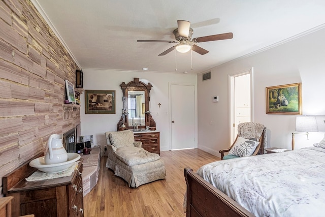 bedroom featuring light hardwood / wood-style floors, ceiling fan, and ornamental molding