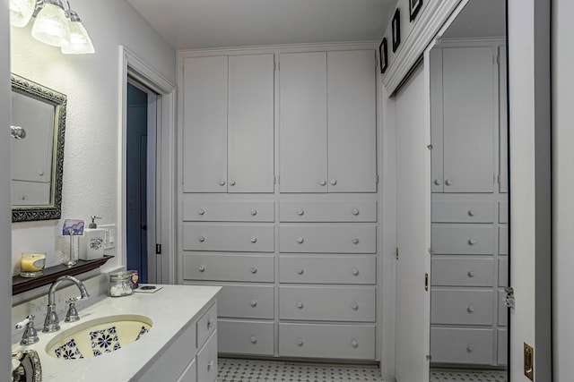 bathroom with vanity and tile flooring