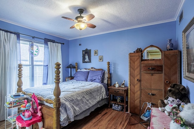 bedroom featuring ceiling fan, ornamental molding, dark wood-type flooring, and a textured ceiling