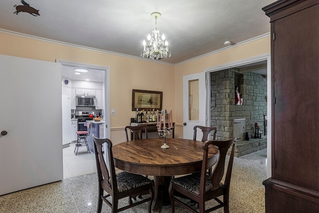 tiled dining area with ornamental molding, a notable chandelier, and a textured ceiling