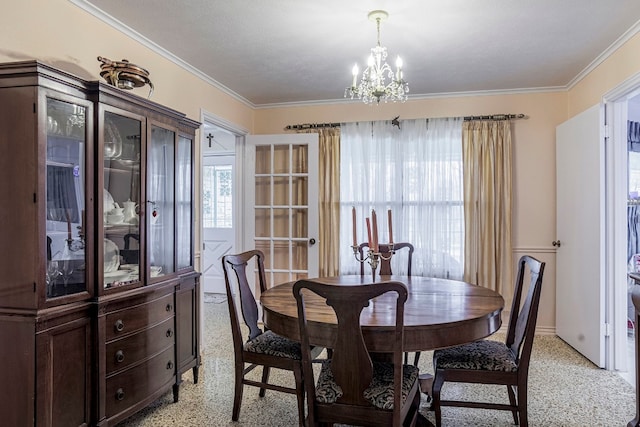 dining room with an inviting chandelier and crown molding