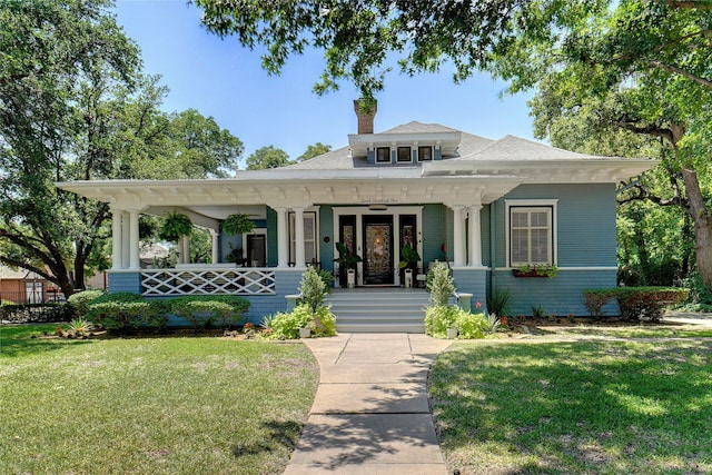 view of front of property featuring covered porch and a front lawn