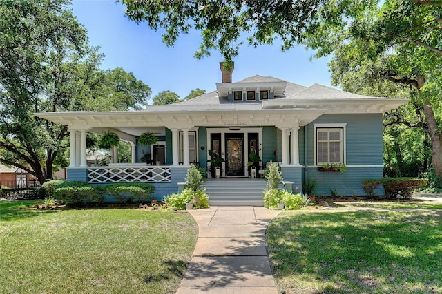 view of front of property with a porch and a front lawn