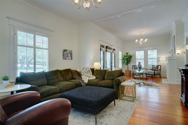 living room with a chandelier, hardwood / wood-style flooring, plenty of natural light, and crown molding