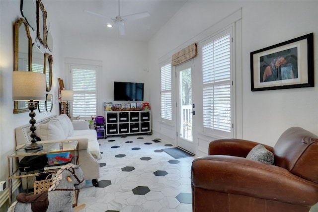 living room featuring a wealth of natural light, ceiling fan, and tile floors