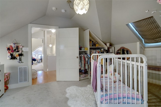 walk in closet with carpet and vaulted ceiling