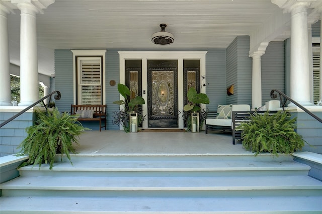 view of exterior entry featuring a porch