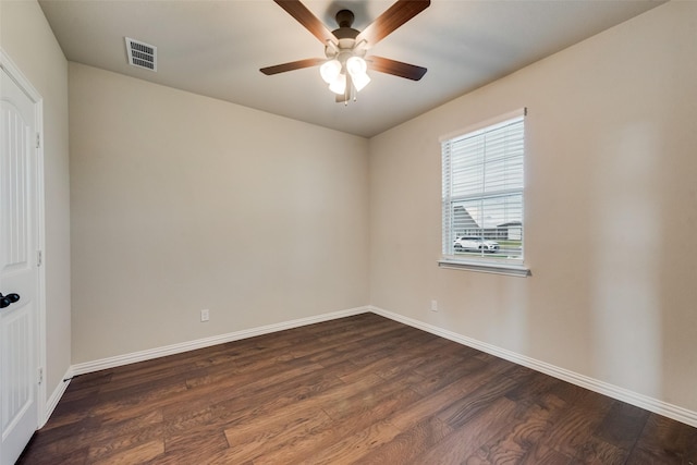 unfurnished room featuring ceiling fan, visible vents, baseboards, and dark wood-style floors