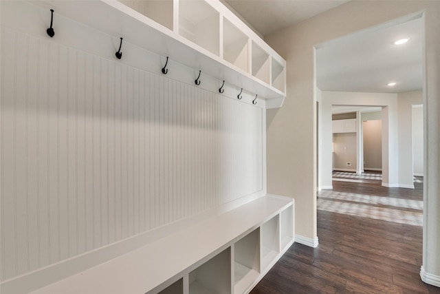 mudroom with dark wood finished floors, recessed lighting, and baseboards