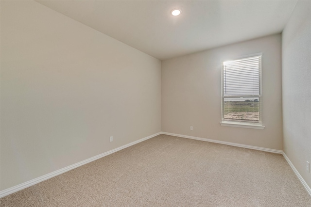 unfurnished room with recessed lighting, light colored carpet, and baseboards