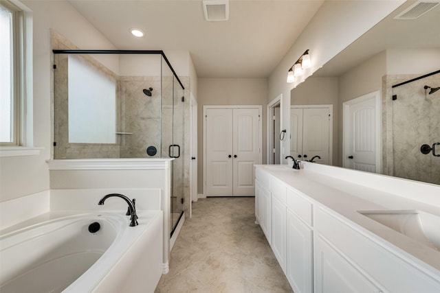 bathroom featuring a sink, visible vents, a garden tub, and a stall shower