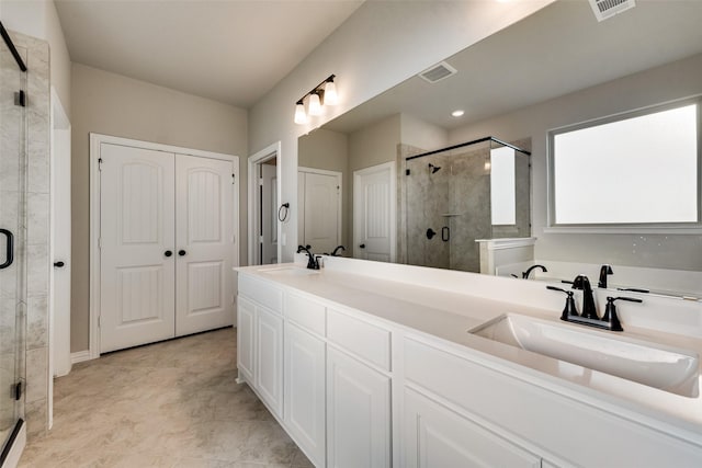 bathroom featuring visible vents, a shower stall, and a sink