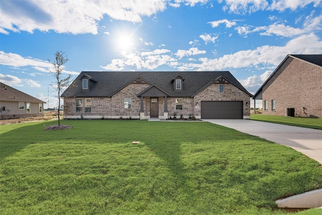 french provincial home featuring brick siding, driveway, a front lawn, and roof with shingles