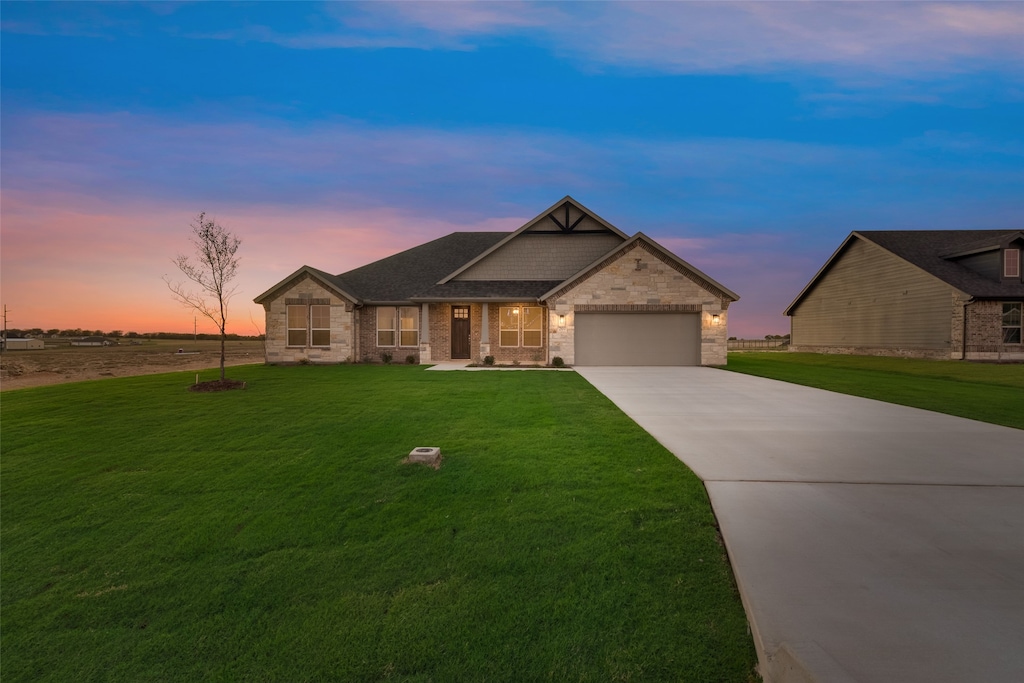 craftsman-style home featuring a yard and a garage