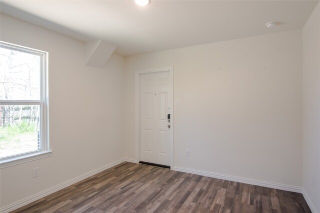 spare room with dark wood-type flooring