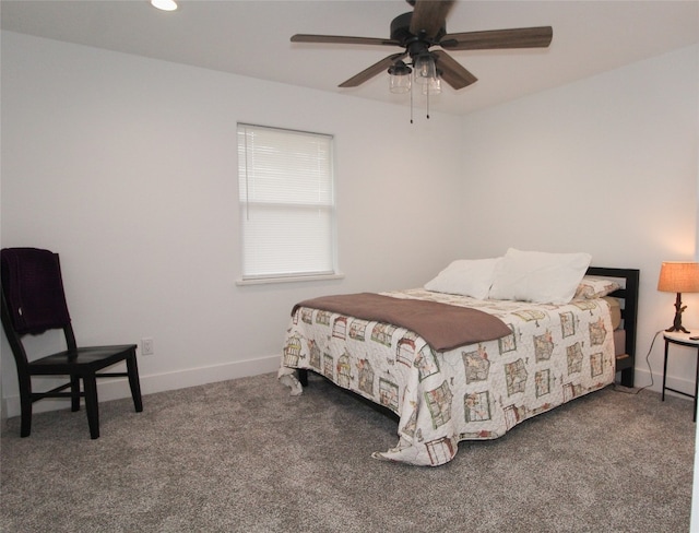 bedroom featuring dark carpet and ceiling fan