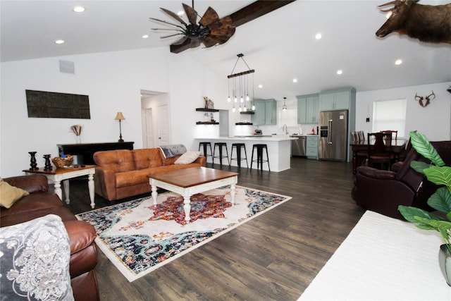 living room featuring high vaulted ceiling, dark wood-type flooring, and ceiling fan with notable chandelier