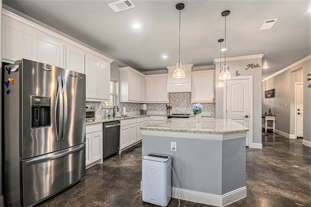 kitchen featuring white cabinets, sink, tasteful backsplash, hanging light fixtures, and stainless steel appliances