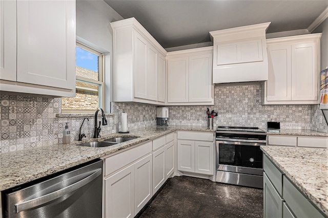 kitchen featuring white cabinetry, appliances with stainless steel finishes, backsplash, light stone counters, and sink