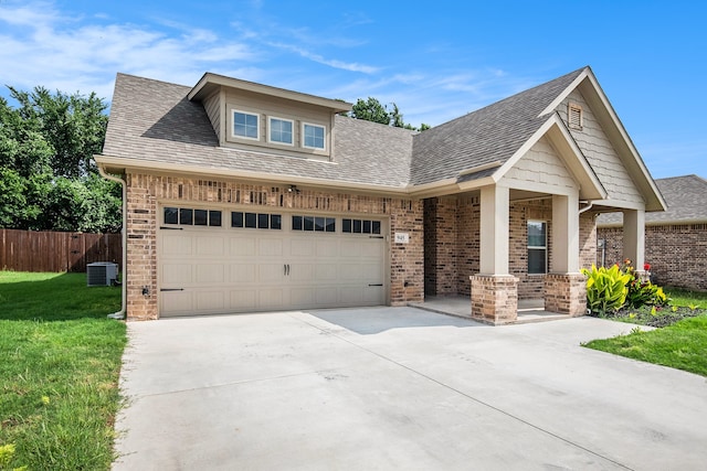 craftsman-style home with a garage, central air condition unit, and a front lawn