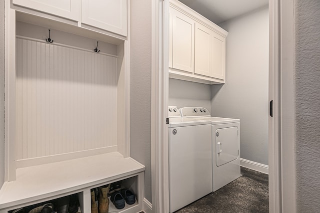 clothes washing area with cabinets and washer and clothes dryer