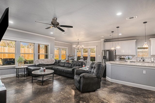 living room with ornamental molding, sink, ceiling fan with notable chandelier, and a textured ceiling