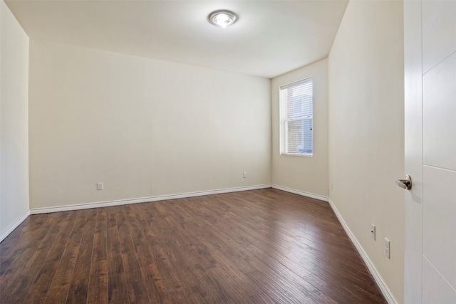 spare room with dark hardwood / wood-style flooring