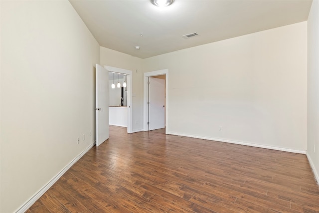 empty room with dark hardwood / wood-style floors