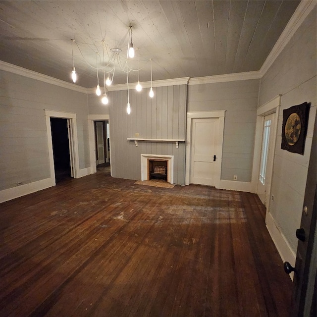 unfurnished living room with ornamental molding, a notable chandelier, and dark hardwood / wood-style floors