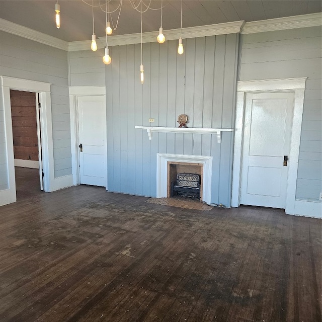 unfurnished living room featuring a chandelier, ornamental molding, and dark wood-type flooring