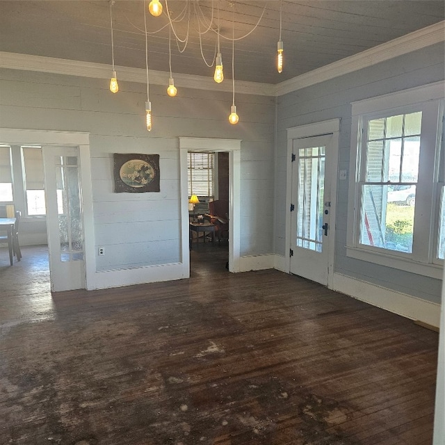 interior space with crown molding, a notable chandelier, and dark wood-type flooring