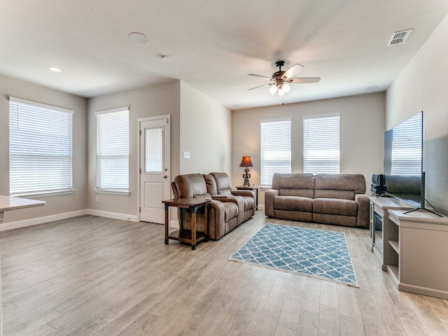 living room with ceiling fan and light hardwood / wood-style floors