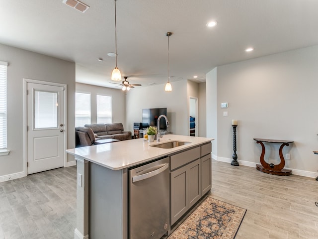 kitchen with ceiling fan, sink, a center island with sink, dishwasher, and gray cabinets