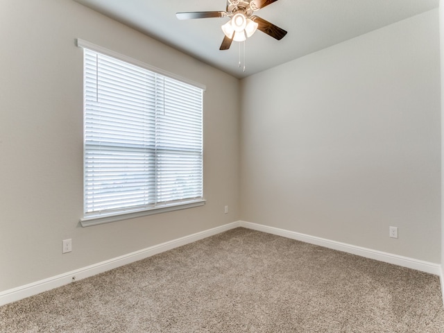 carpeted spare room with ceiling fan and a healthy amount of sunlight