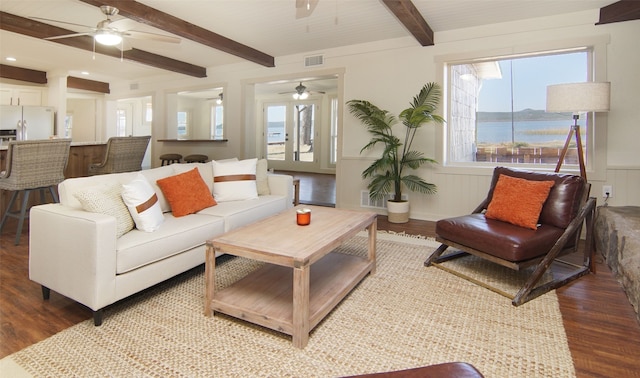 living room with beamed ceiling, ceiling fan, and hardwood / wood-style flooring